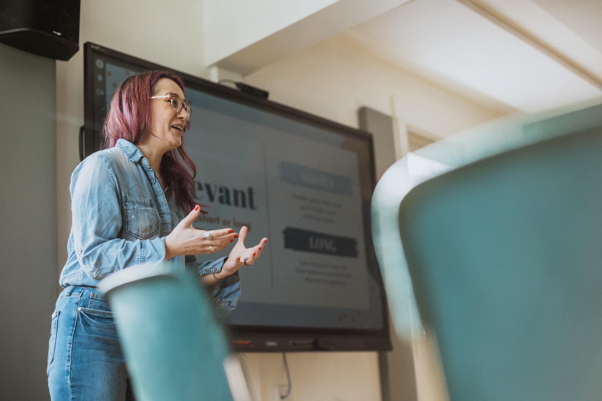 Tera is facilitating in front of a smartboard.